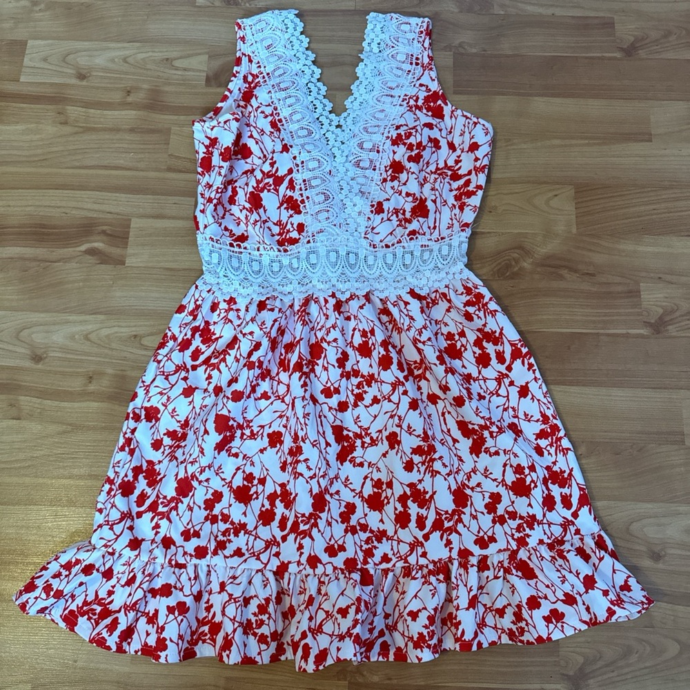 Red & white floral dress with lace trim and ruffle hem, featuring a V neckline.